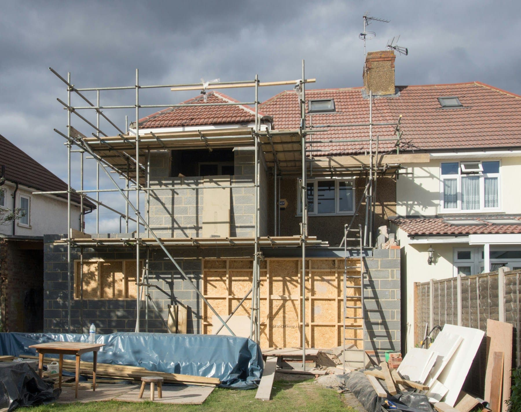A semi-detached house with a single-storey extension under scaffolding